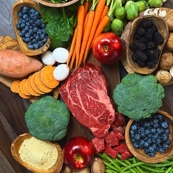 Fresh whole food ingredients — beef, vegetables, and eggs